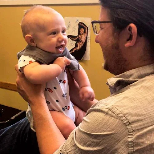 Chiropractic Kirkland WA Ehren Pace HP Ehren Pace carrying a baby looking very cute
